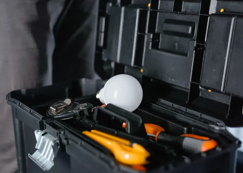 An open toolbox of hand tools and spare parts carried on the truck.
